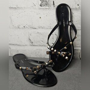 Streetwear Society Black Jelly Flip Flops with Brass Studs on the Bows.